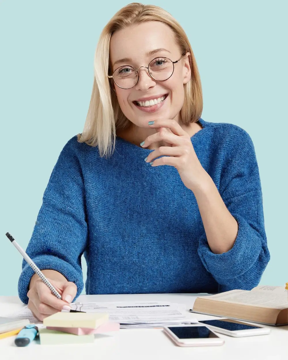 portrait of positive female copywriter works alone writes notes uses dictionary for creating new a 1